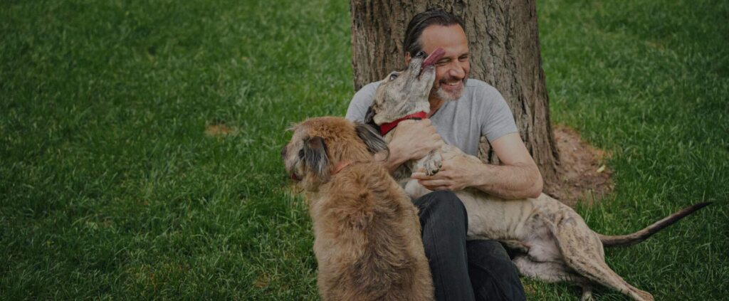 A man hugging a dog at dog training in Houston, Texas called Puptown Houston.